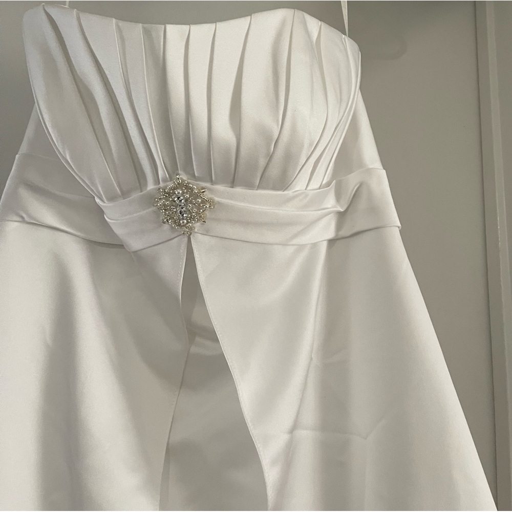 White wedding Dress. It’s New and Clean. With a Beautiful Rock in the Front.